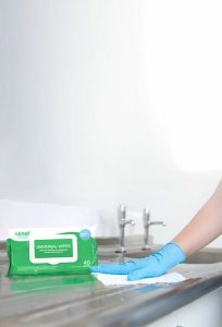 Cleaning Counter with Green Clinell Wipes Standing Up