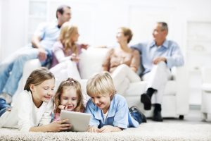 Three cute kids using a digital tablet.